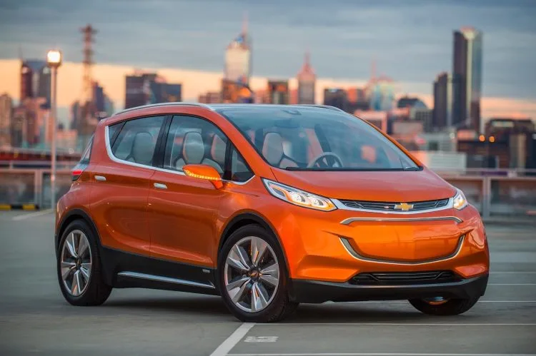 2015 Chevrolet Bolt EV Concept all electric vehicle. Front ¾ in city scape. Bolt EV Concept builds upon Chevy’s experience gained from both the Volt and Spark EV to make an affordable, long-range all-electric vehicle to market. The Bolt EV is designed to meet the daily driving needs of Chevrolet customers around the globe with more than 200 miles of range and a price tag around $30,000.
