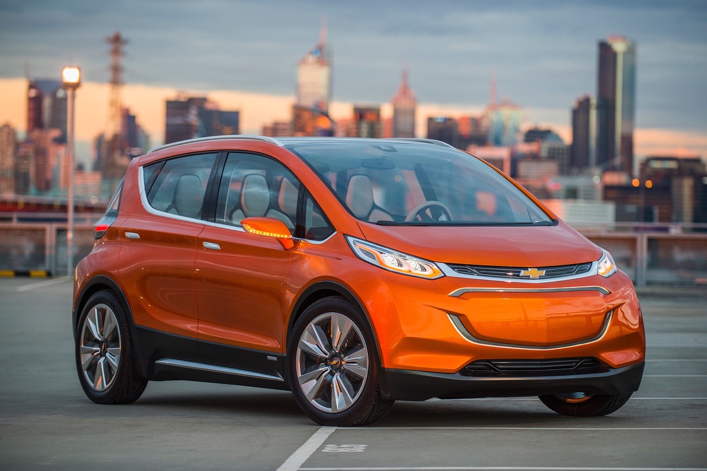 2015 Chevrolet Bolt EV Concept all electric vehicle. Front ¾ in city scape. Bolt EV Concept builds upon Chevy’s experience gained from both the Volt and Spark EV to make an affordable, long-range all-electric vehicle to market. The Bolt EV is designed to meet the daily driving needs of Chevrolet customers around the globe with more than 200 miles of range and a price tag around $30,000.
