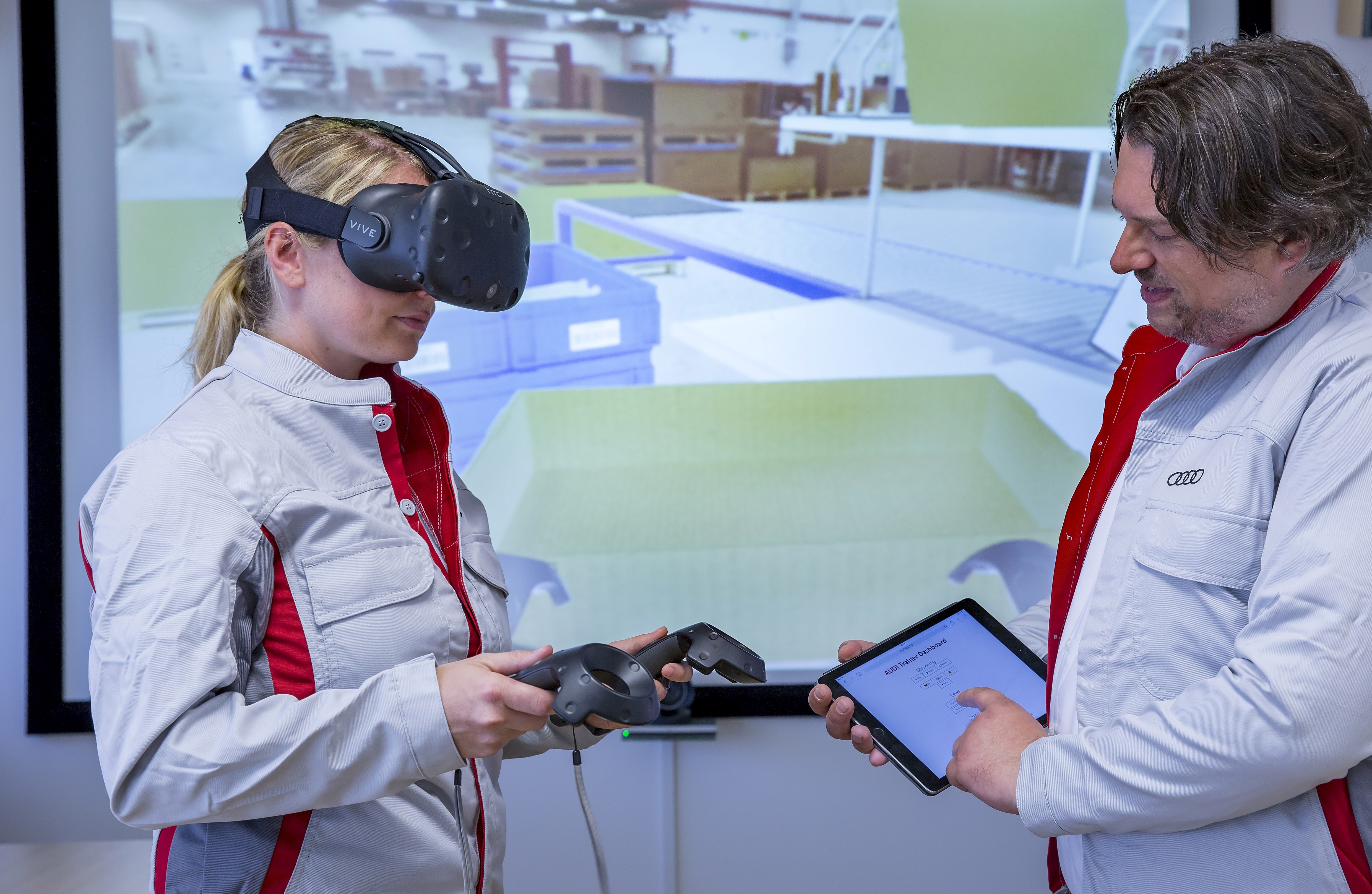 Together with a trainer, an Audi Packing Logistics employee practices the proper techniques for packing brake discs and other large parts for shipping overseas. Thanks to a pair of virtual reality glasses, she can train in a realistic and true-to-life simulation of her work station in Hall L of the Ingolstadt Logistics Center.