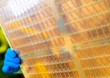 An Intel engineer holds a test glass core substrate panel at Intel's Assembly and Test Technology Development factories in Chandler, Arizona, in July 2023. Intel’s advanced packaging technologies come to life at the company's Assembly and Test Technology Development factories. (Credit: Intel Corporation)
